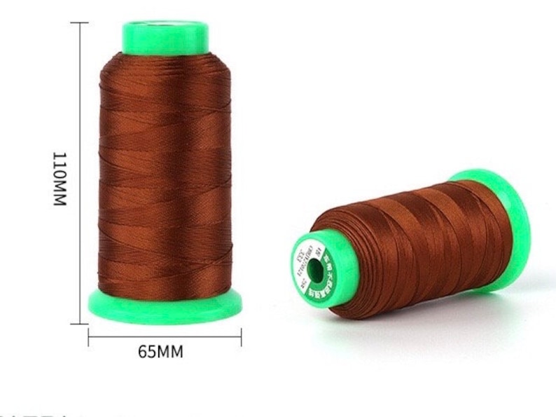 May include: Two spools of brown thread with green plastic caps. The spools are 110mm tall and 65mm wide.