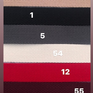 May include: Six different colors of woven fabric strips with numbers 3, 1, 5, 54, 12, and 55 printed on them.