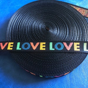 May include: Black webbing with the word "LOVE" repeated in rainbow colors.