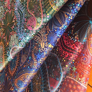 May include: Three fabric swatches with paisley patterns in shades of blue, green, and red. The fabrics are folded over each other, creating a layered effect.