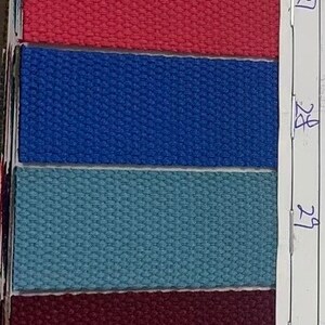 May include: A sample card with 12 fabric swatches, numbered 23 through 34. The swatches are in various colors, including beige, blue, green, brown, red, and teal.