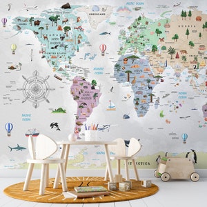 May include: A detailed world map mural featuring illustrations of animals and landmarks. The map is on a wall, with a small table and chairs in front. A round rug and wooden toys are on the floor, creating a playful learning space.