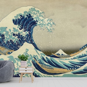 May include: A large blue wave with white foam crests, crashing over three traditional Japanese boats. The wave is depicted in a classic Japanese woodblock print style, with a background of light blue and white. The text in the upper left corner reads "神奈川沖浪裏" (Kanagawa oki nami ura), which translates to "Under the Wave off Kanagawa".