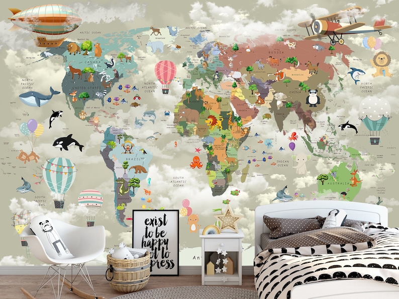 May include: A wall mural featuring a colorful world map with cartoon animals, hot air balloons, and airplanes set against a cloudy sky. A framed sign with the text "exist to be happy not to impress" sits on the floor near a white chair and bed.