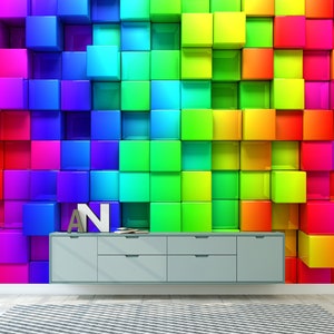 May include: A wall covered in colorful, glossy, square tiles in a rainbow pattern. The tiles are arranged in a staggered pattern, creating a 3D effect. A gray cabinet with drawers sits in front of the wall.