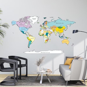 May include: A large, colorful world map wall decal featuring distinct pastel-colored countries and continents. The map includes clearly labeled text for major nations such as the United States, Canada, Brazil, Russia, China, and Australia, with Antarctica at the base.