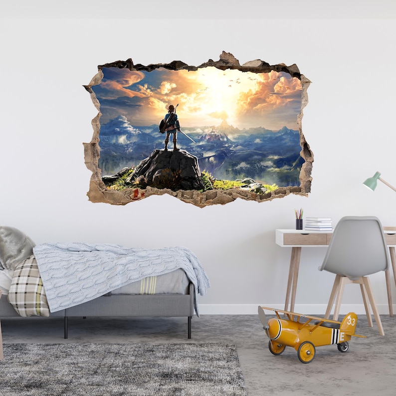 Puede incluir: Un adhesivo de pared con efecto 3D que muestra un agujero en la pared revelando un paisaje. Una figura se encuentra sobre una roca frente a una cordillera bajo un cielo de atardecer dorado con nubes. El dise&ntilde;o tiene bordes de papel rasgado.