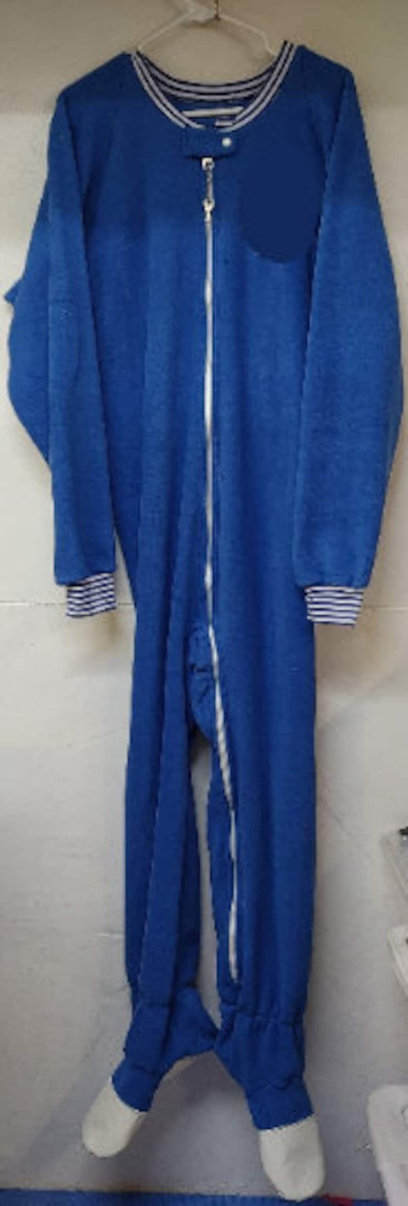 May include: A blue fleece one-piece sleepwear with a zipper closure and white trim around the neck and cuffs.