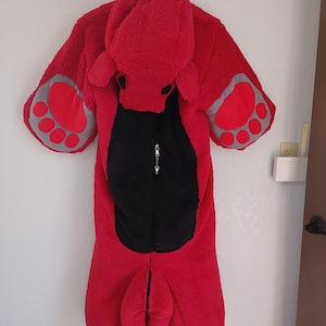 May include: Red and black hooded animal onesie with paw print details on the sleeves. The onesie is made of a soft, plush material.