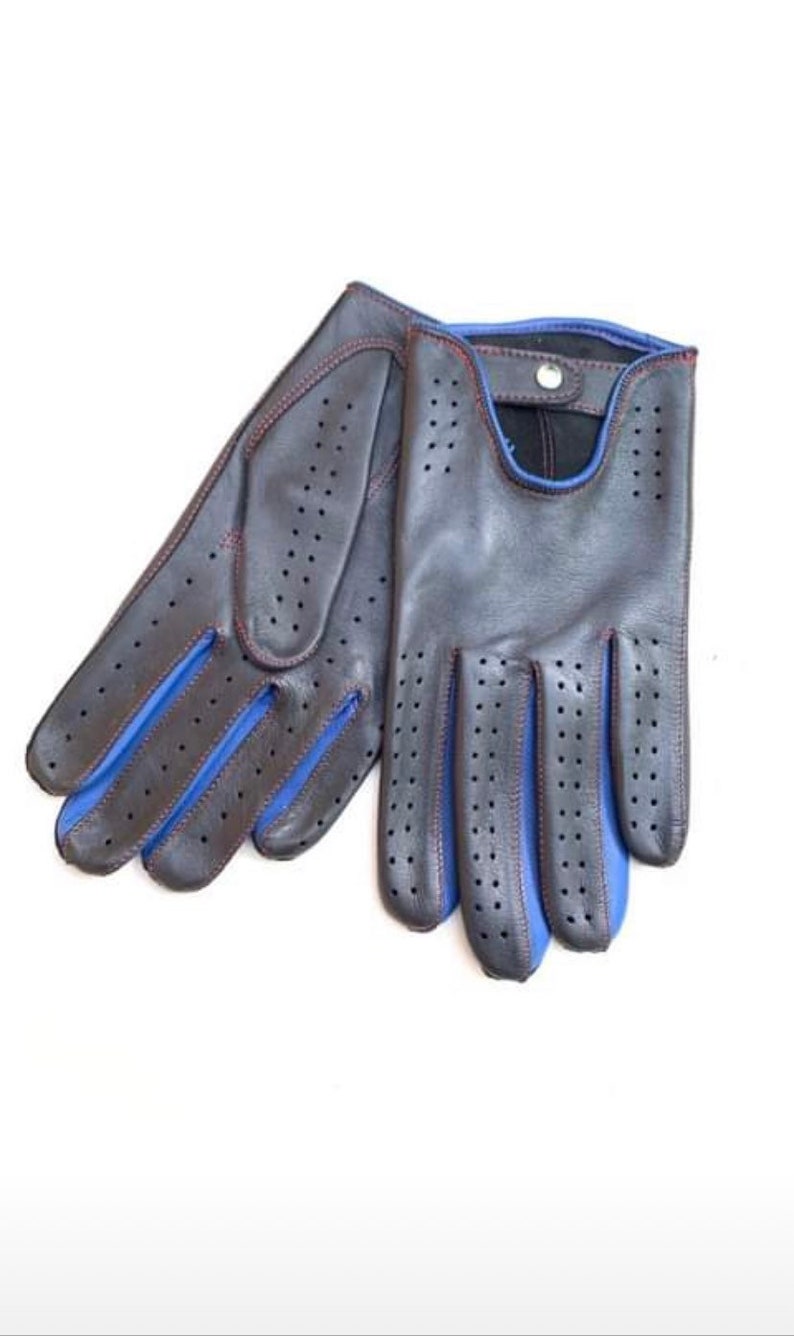 May include: A pair of black leather driving gloves with blue stitching and perforated detailing. The gloves have a red accent along the seams.