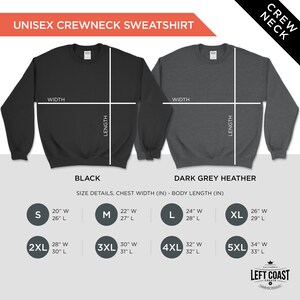 May include: Size chart for a unisex crewneck sweatshirt in black and dark grey heather. The chart shows the chest width and body length in inches for sizes S, M, L, XL, 2XL, 3XL, 4XL, and 5XL.