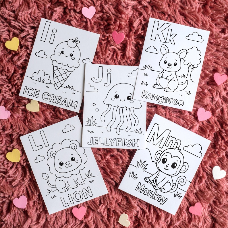 Five white coloring pages with black outlines of cute illustrations. The pages feature the letters I, J, K, L, and M, along with the words "ICE CREAM", "JELLYFISH", "Kangaroo", "LION", and "Monkey". Pink and yellow heart-shaped decorations are scattered around.