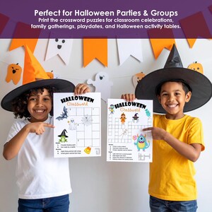 Two kids in witch hats holding printable Halloween crossword worksheets for a Halloween party or classroom game.