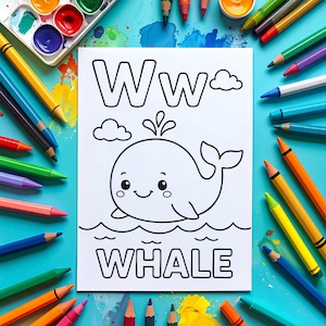 A white coloring page featuring a cartoon whale with the letter "W" and the word "WHALE". The page is surrounded by colorful pencils, paint, and a palette on a blue surface, creating a vibrant art supply theme.