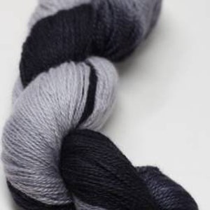 May include: A skein of yarn in a gradient of black and grey colors.