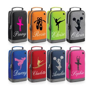 May include: Eight personalised shoe bags in a variety of colours and designs. The bags feature a range of dance-themed silhouettes, including ballerinas, cheerleaders, and a breakdancer. Each bag has a name printed on it, such as Penny, Rosie, Eloise, Olivia, Darcey, Charlotte, Amelia, and Sophie.