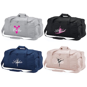 May include: Four different coloured duffel bags with personalised embroidery. The bags are grey, black, navy blue, and pink. The embroidery includes a cheerleader, a ballerina, and the names Chloe, Abigail, Sophia, and Lillie.