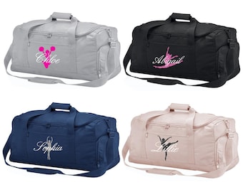 May include: Four different color duffel bags with personalized embroidery. The bags are gray, black, navy blue, and pink. The embroidery includes a cheerleader, a ballerina, and the names Chloe, Abigail, Sophia, and Lillie.