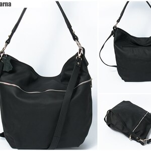May include: A black leather tote bag with a zipper closure and a long adjustable strap. The bag has a slouchy design and is perfect for everyday use.