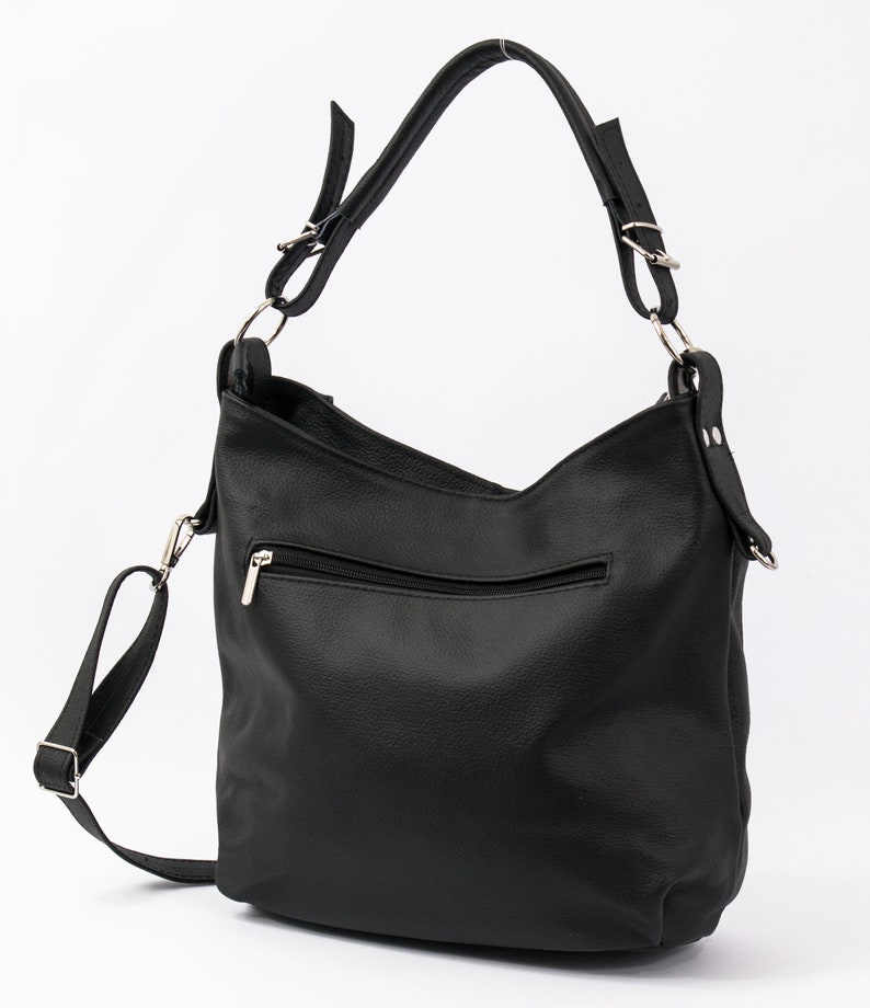 May include: Black leather shoulder bag with a zippered pocket and a long adjustable strap.