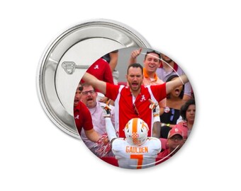 May include: A red and white button featuring a photo of a football player in a white jersey with the number 7 and the name "GAULDEN" on the back, celebrating a touchdown with his arms raised in the air. The player is surrounded by fans wearing red and white clothing.