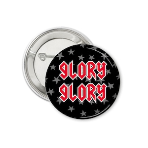May include: A black button with a white star pattern and the words "Glory Glory" in red.