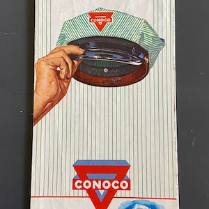 May include: Vintage travel brochure for Wyoming, "The Equality State," featuring a Conoco gas station logo and a depiction of Yellowstone Park. The brochure includes a Conoco service cap and the text "On your way west- visit CONOCO in YELLOWSTONE PARK."