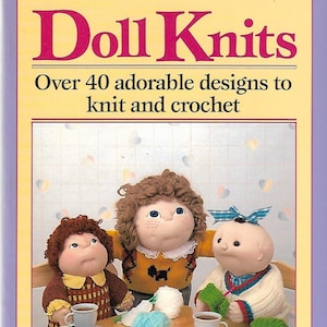 May include: Book cover titled "Doll Knits" with text "Over 40 adorable designs to knit and crochet." Features three dolls wearing knitted outfits, with yarn and teacups on a table. The authors are Zazel Loven and Patricia Ann Higgins.