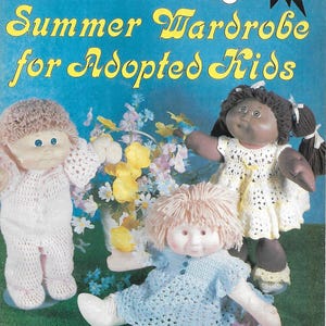 May include: Magazine cover for "Doll World" showing three dolls in crocheted clothes. The text says "Summer Wardrobe for Adopted Kids." The dolls are dressed in white, yellow, and blue crocheted outfits. The background is blue and green.
