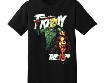 May include: Black t-shirt featuring a graphic of Jason Voorhees from Friday the 13th. The design includes Jason in his hockey mask, holding a machete, with the words "FRIDAY" and "THE 13TH" in green and white.