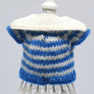 May include: A blue and white striped knitted sweater with a white collar. The sweater is on a white mannequin.