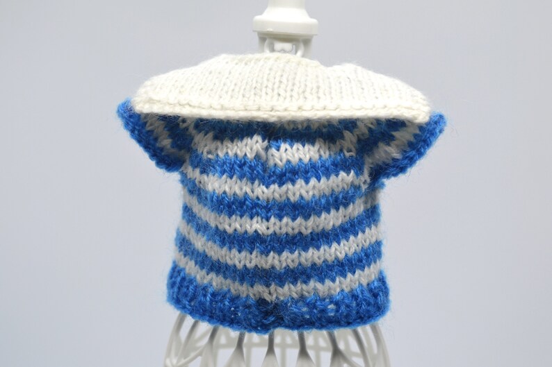 May include: A blue and white striped knitted sweater with a white collar. The sweater is on a white mannequin.