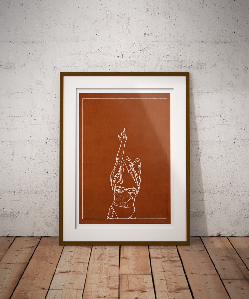 May include: A white line drawing of a person with their arm raised in the air, making a middle finger gesture. The drawing is on a brown background and framed in a white frame with a brown wood border.