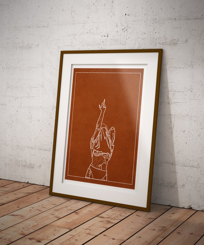 May include: A framed print with a brown background and a white line drawing of a person with their arm raised in the air, making a middle finger gesture.