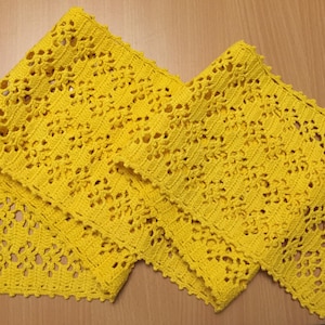 May include: Yellow crocheted lace trim, a delicate and intricate design with a repeating pattern of flowers and leaves.