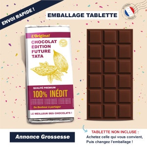 May include: A brown chocolate bar wrapper with the text "L'Original Chocolat Edition Future Tata" and "Qualit&eacute; Premium 100% In&eacute;dit". The wrapper is decorated with a cocoa pod illustration. The text "Annonce Grossesse" is at the bottom of the image. The text "TABLETTE NON INCLUSE: Achetez celle qui vous convient, Puis changez l'emballage!" is at the bottom right of the image.