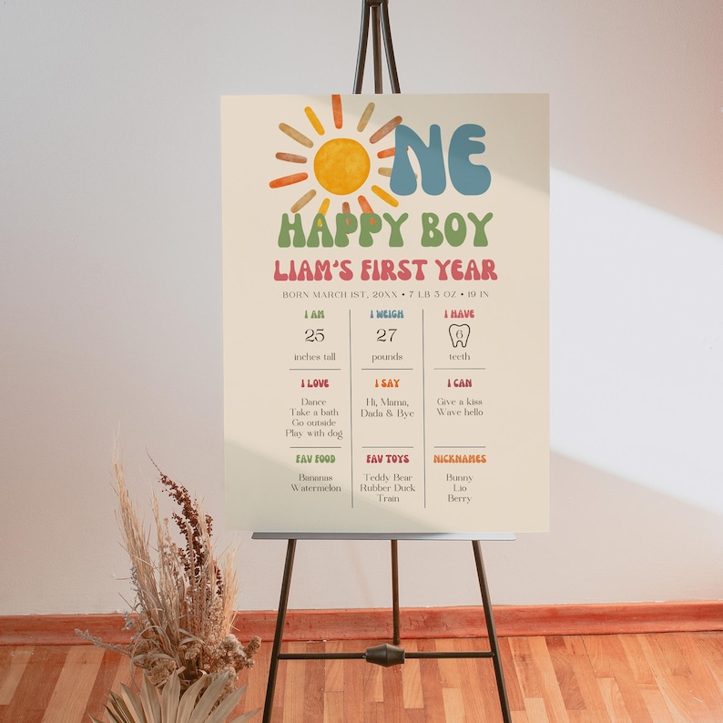 Large first birthday milestone board in easel format highlighting baby stats and favorites, decorated with sun and colorful lettering in boho retro style.