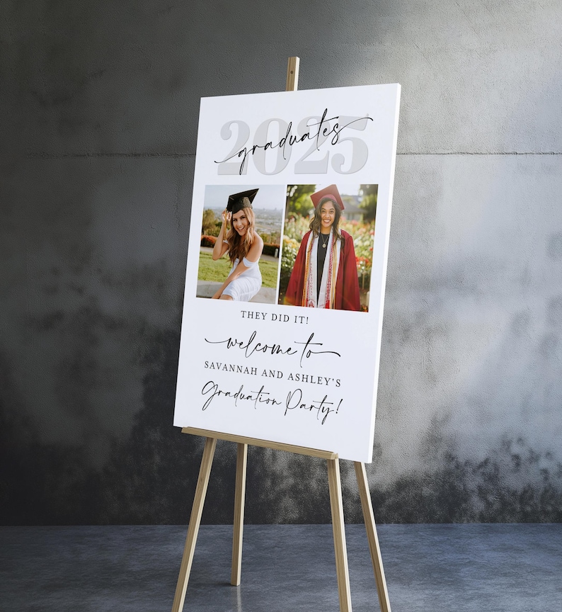 A personalized dual graduation welcome sign displayed on a wooden easel, featuring two graduate photos—one in a white dress and the other in a red cap and gown. "2025" is styled in bold with “graduates” in modern script, and “They Did It! Welcome to Savannah and Ashley’s Graduation Party!” is written below. Ideal for joint high school or college parties using this editable Canva template.