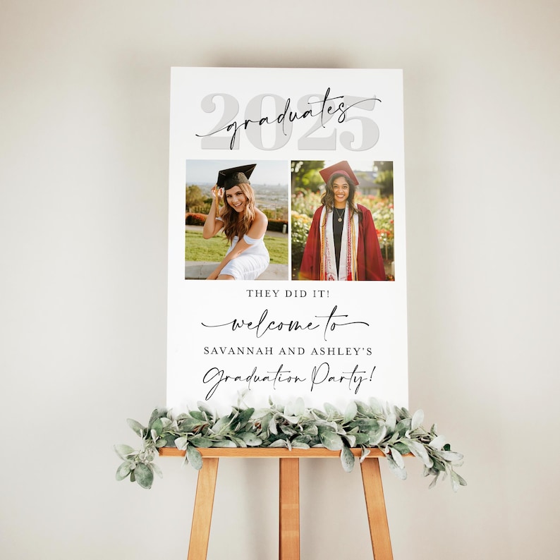 Graduation poster with dual photo design and minimal script typography on a wooden easel with a greenery accent. Text reads “They Did It! Welcome to Savannah and Ashley’s Graduation Party,” placed beneath the bold “2025” and “graduates” script. An editable and printable Canva template suited for modern dual grad celebrations.