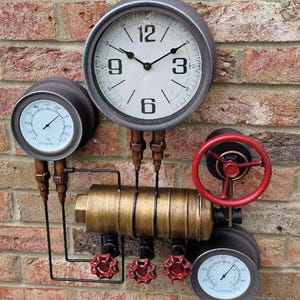 May include: A decorative steampunk-style wall clock featuring a round, white clock face with black hands, metal pipes, gauges, and red valve handles. The clock is mounted on a red brick wall, creating a vintage industrial aesthetic.