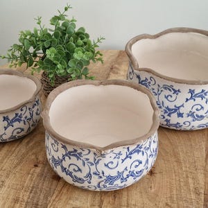 May include: A trio of ceramic mugs with a speckled, matte finish in cream, light grey, and dark grey. Each mug features a minimalist design and a rounded handle. Ideal for tea or coffee.