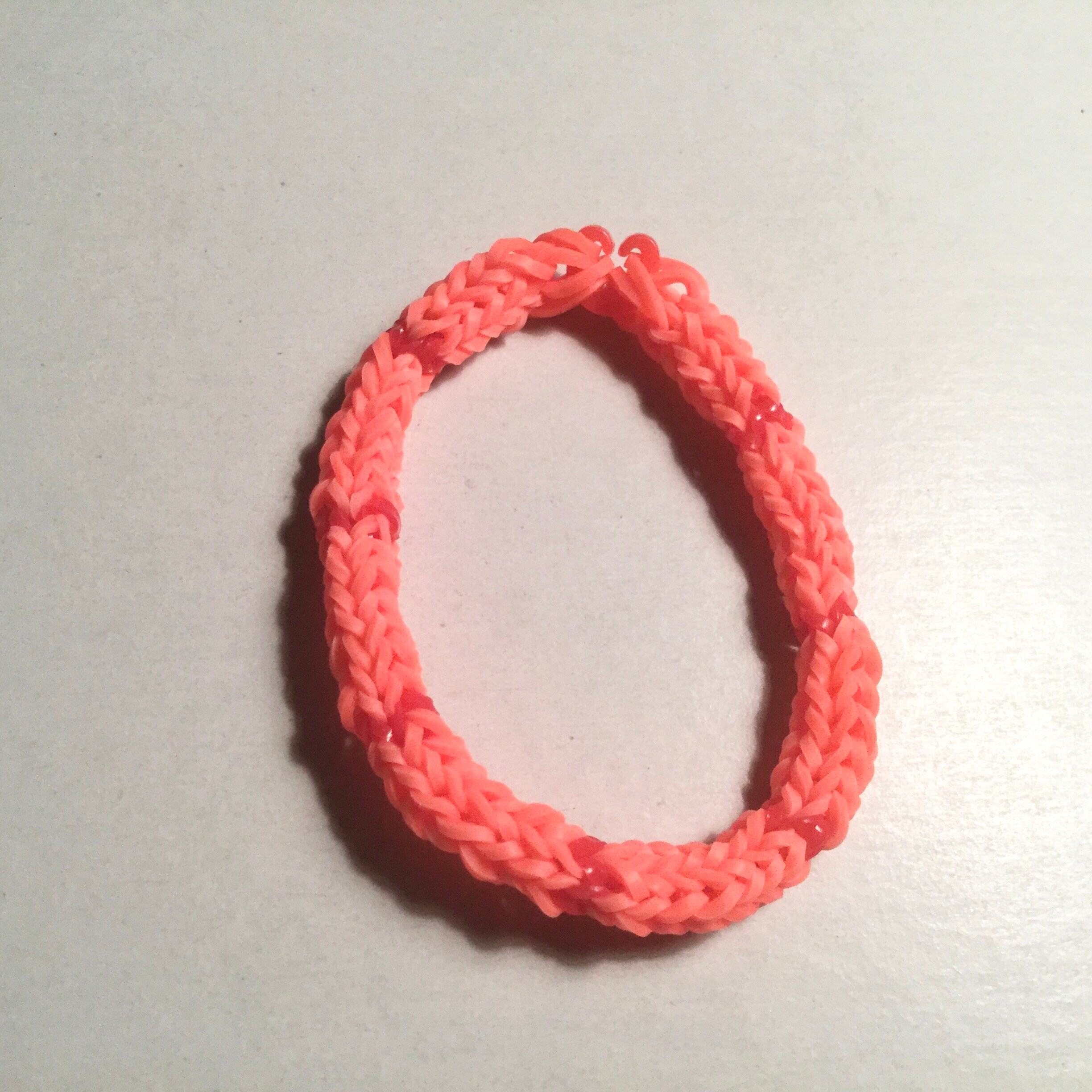 Tangerine orange and red woven rubber band bracelet