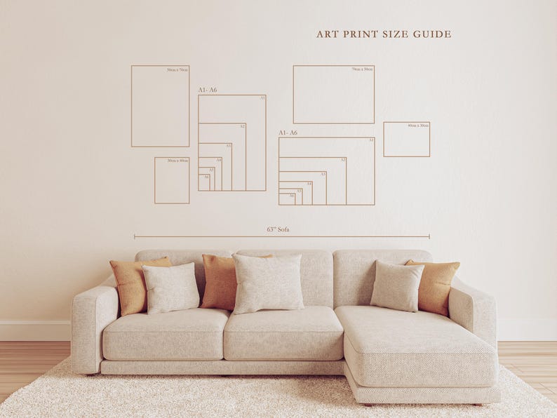May include: An art print size guide is displayed on a beige wall above a beige sectional sofa with throw pillows. The guide shows various rectangular shapes with size labels. The sofa is on a white rug.