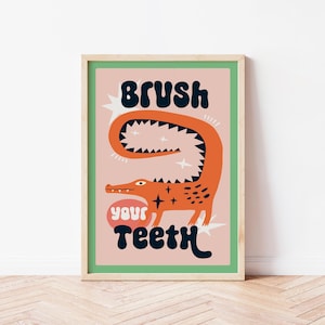 以下が含まれることがあります： ピンクとグリーンのイラストが描かれたポスター。漫画のワニが「Brush Your Teeth」という文字を黒と白で書いている。