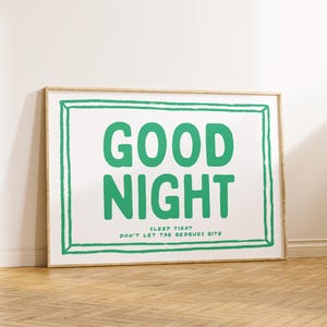 May include: A framed print with a white background and a green border. The text "GOOD NIGHT" is written in large green letters. Below the text is the phrase "SLEEP TIGHT DON'T LET THE BEDBUGS BITE".