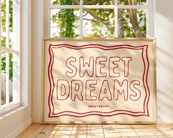 May include: A framed print with a cream background and a red double-lined border. The text "SWEET DREAMS" is written in red with a rounded font. The text "SWEETHEART" is written in smaller red letters below the main text.