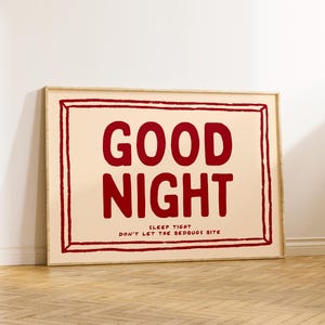 May include: A framed print with a peach background and a red inscription that reads "GOOD NIGHT SLEEP TIGHT DON'T LET THE BEDBUGS BITE".