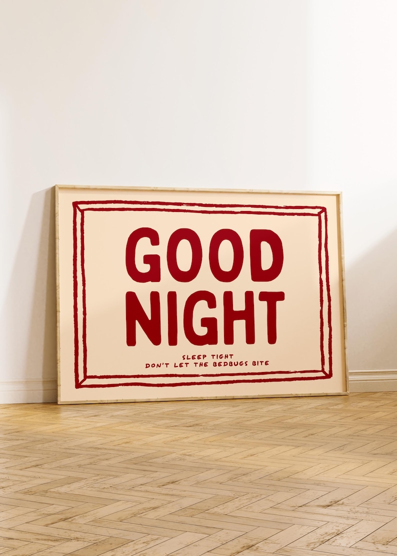 May include: A framed print with a peach background and a red inscription that reads "GOOD NIGHT SLEEP TIGHT DON'T LET THE BEDBUGS BITE".