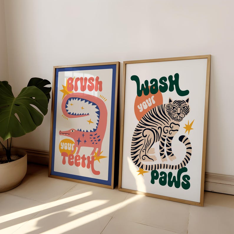 K&ouml;nnte beinhalten: Zwei gerahmte Drucke mit bunten Illustrationen und Text. Der linke Druck zeigt ein pinkfarbenes Alligator mit dem Text "Putze deine Z&auml;hne". Der rechte Druck zeigt einen Tiger mit dem Text "Wasche deine Pfoten".