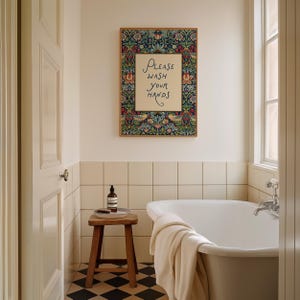 May include: A bathroom interior with a framed sign saying "Please Wash Your Hands." The sign has a floral border. A wooden stool holds a bottle and a brush. A white bathtub and a black and white checkered floor are also visible.